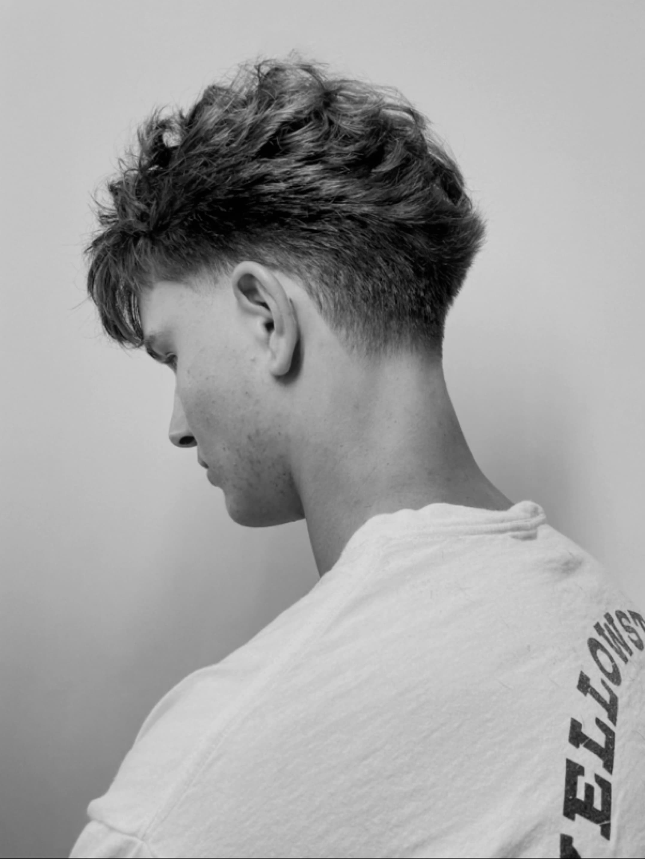An authentic Star Barber haircut, shown from the side with its full shape and shoulder line