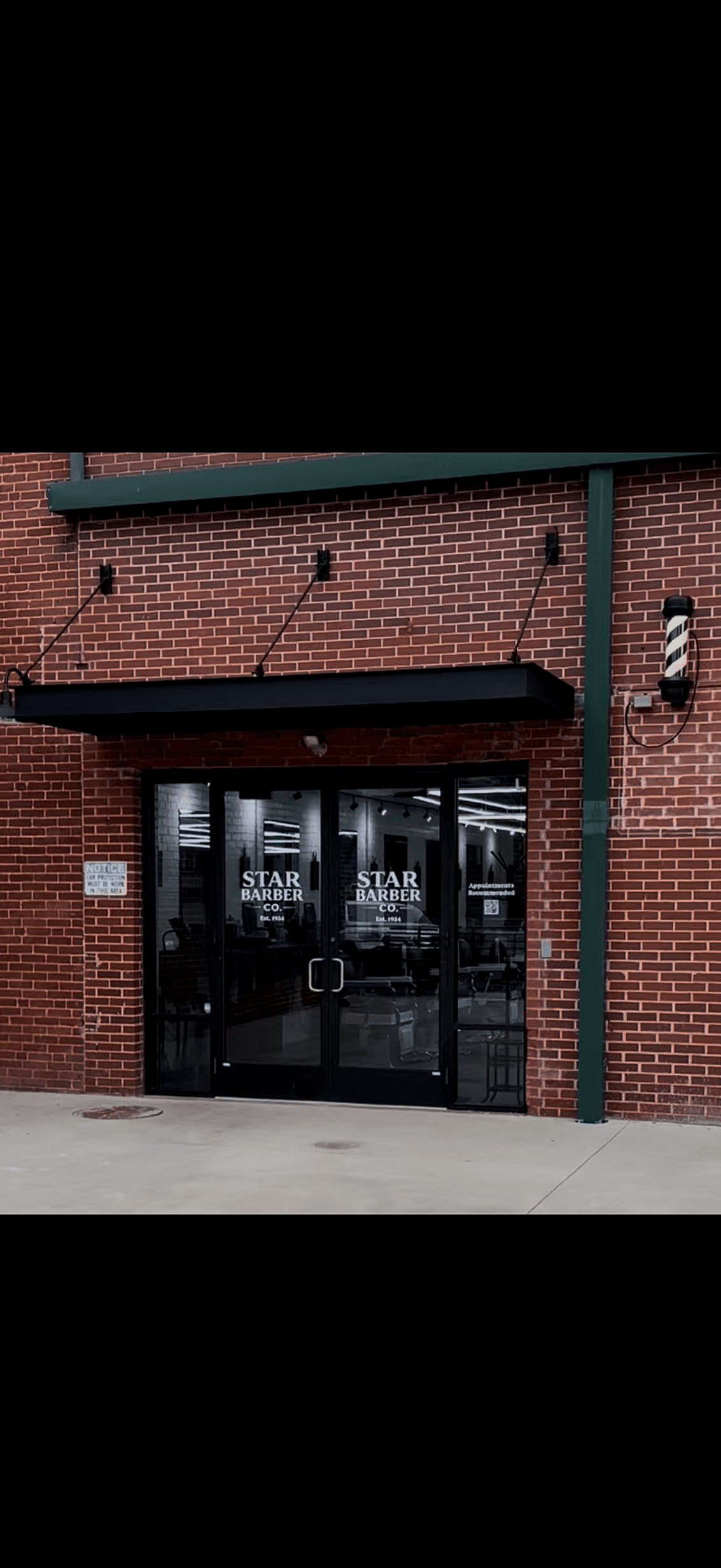 The actual Star Barber Company entrance on Smythe Street, with its signed double doors and striped barber pole